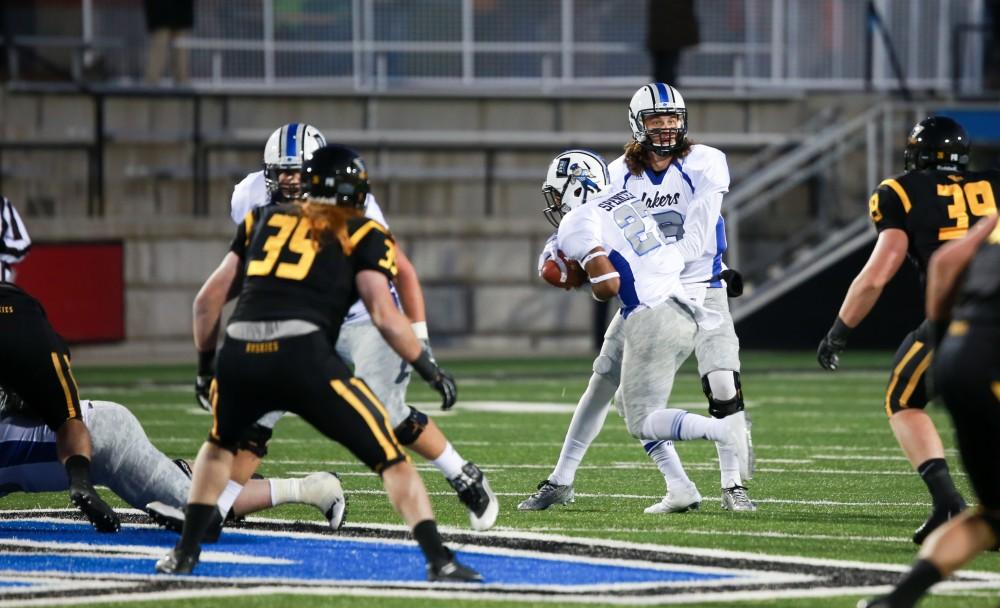 GVL / Kevin Sielaff -  Bart Williams (6) hands the ball off to Kirk Spencer (27). Grand Valley squares off against Michigan Tech Oct. 17 at Lubbers Stadium in Allendale. The Lakers defeated the Huskies with a score of 38-21.