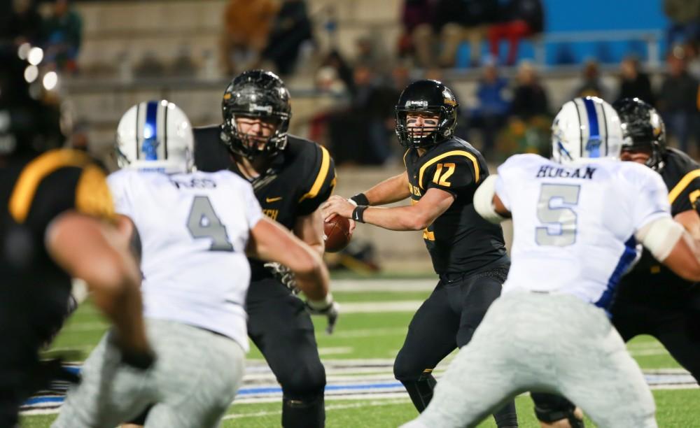 GVL / Kevin Sielaff -  Michigan Tech's Brandon Cowie (12) looks to throw the ball. Grand Valley squares off against Michigan Tech Oct. 17 at Lubbers Stadium in Allendale. The Lakers defeated the Huskies with a score of 38-21.