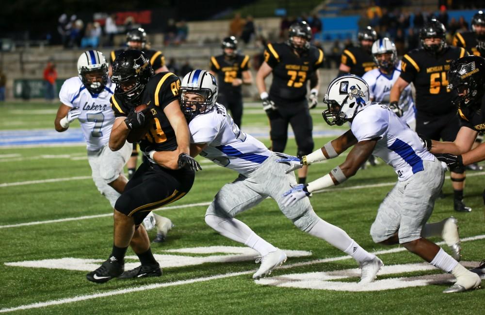 GVL / Kevin Sielaff -  Garrett Pougnet (25) stops the Huskies advance. Grand Valley squares off against Michigan Tech Oct. 17 at Lubbers Stadium in Allendale. The Lakers defeated the Huskies with a score of 38-21.