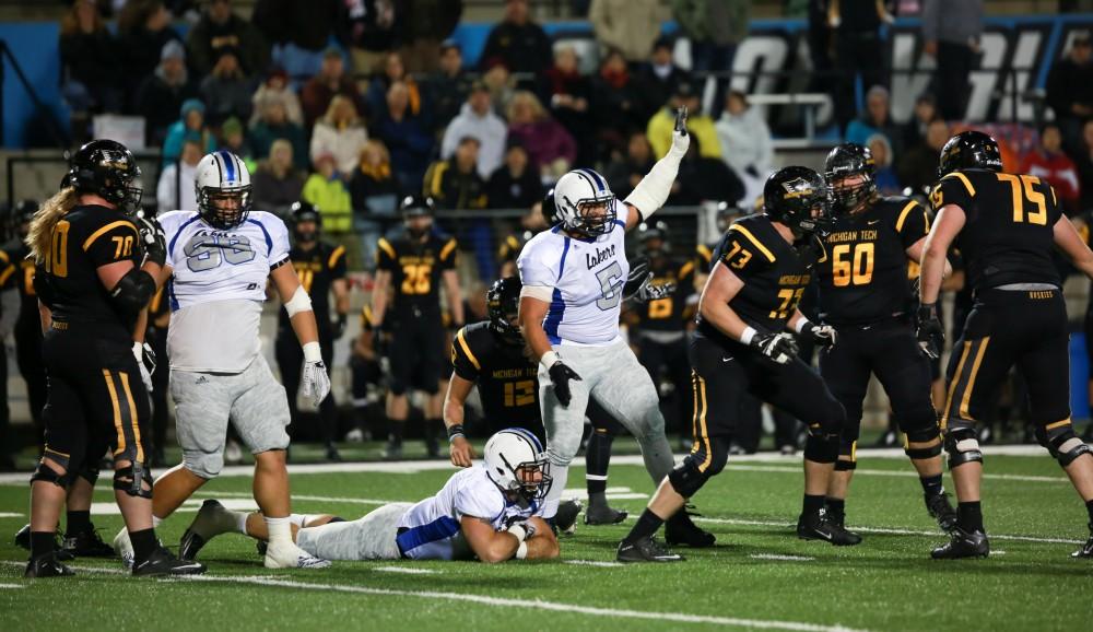 GVL / Kevin Sielaff -  De'Ondre Hogan (5) signals a change of posession after a Huskie turn over. Grand Valley squares off against Michigan Tech Oct. 17 at Lubbers Stadium in Allendale. The Lakers defeated the Huskies with a score of 38-21.