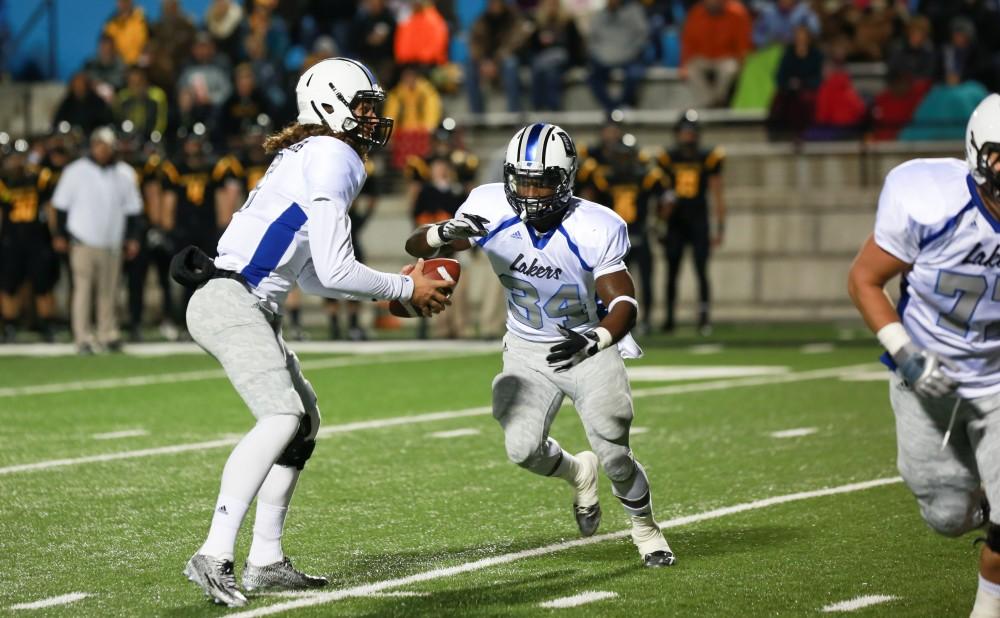 GVL / Kevin Sielaff -  Bart Williams (6) hands the ball off to Marty Carter (34).  Grand Valley squares off against Michigan Tech Oct. 17 at Lubbers Stadium in Allendale. The Lakers defeated the Huskies with a score of 38-21.