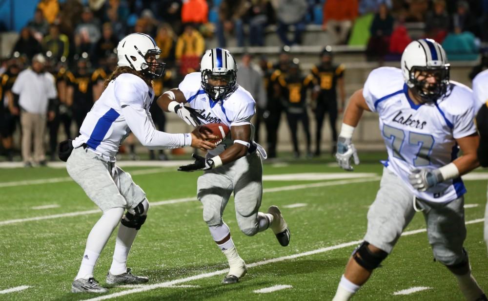 GVL / Kevin Sielaff -  Bart Williams (6) hands the ball off to Marty Carter (34).  Grand Valley squares off against Michigan Tech Oct. 17 at Lubbers Stadium in Allendale. The Lakers defeated the Huskies with a score of 38-21.