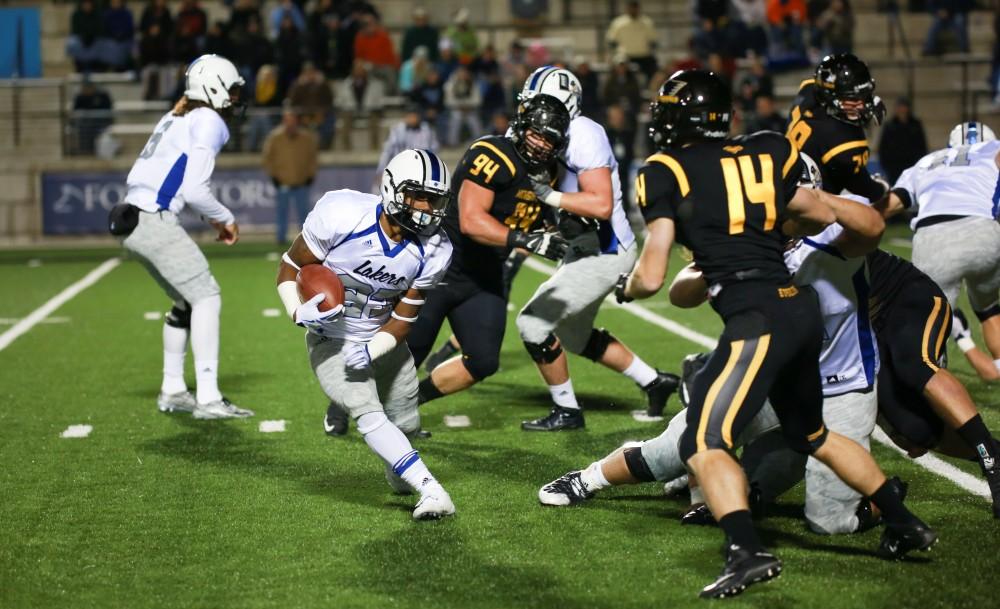 GVL / Kevin Sielaff -  Kirk Spencer (27) jukes toward the end zone.  Grand Valley squares off against Michigan Tech Oct. 17 at Lubbers Stadium in Allendale. The Lakers defeated the Huskies with a score of 38-21.