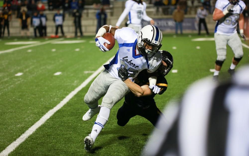 GVL / Kevin Sielaff -  Kirk Spencer (27) is brought to the ground.  Grand Valley squares off against Michigan Tech Oct. 17 at Lubbers Stadium in Allendale. The Lakers defeated the Huskies with a score of 38-21.