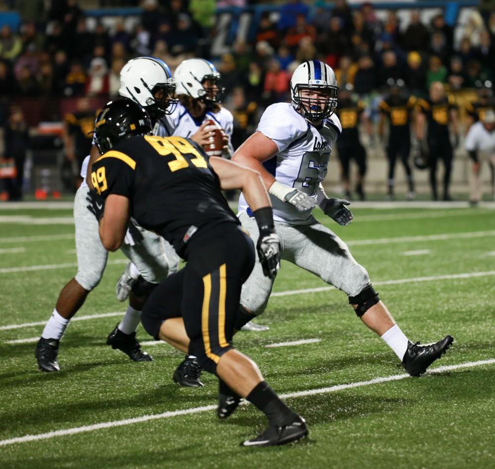 GVL / Kevin Sielaff -  Ben Walling (63) back pedals to block Bart Williams (6).  Grand Valley squares off against Michigan Tech Oct. 17 at Lubbers Stadium in Allendale. The Lakers defeated the Huskies with a score of 38-21.