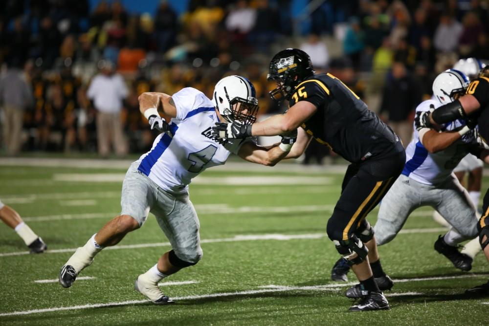 GVL / Kevin Sielaff -  A;tpm Voss (4) pushes his way into the Huskie offense.  Grand Valley squares off against Michigan Tech Oct. 17 at Lubbers Stadium in Allendale. The Lakers defeated the Huskies with a score of 38-21.