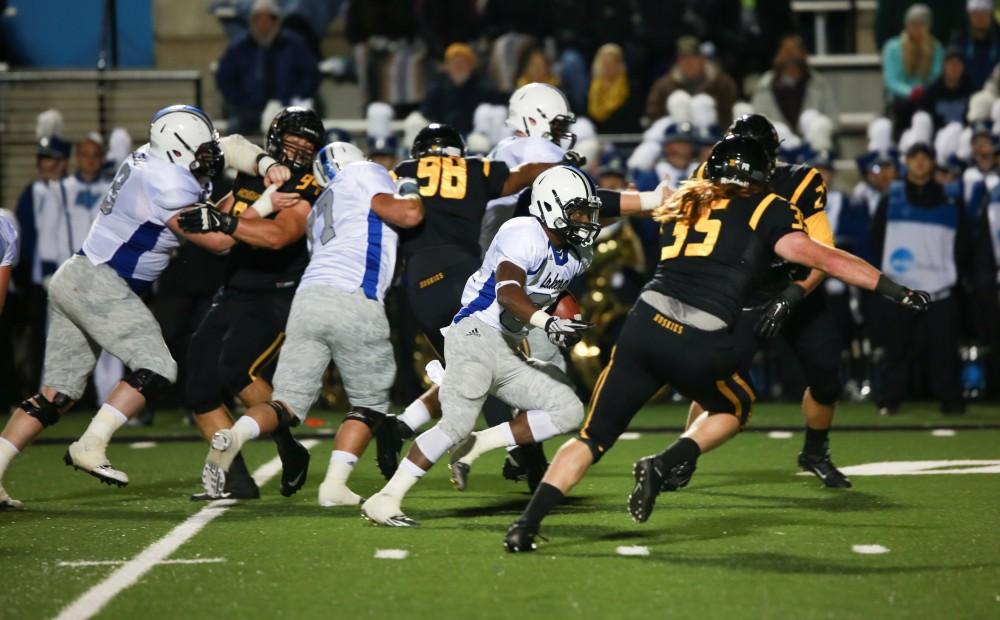 GVL / Kevin Sielaff -   Marty Carter (34) pushes the ball up field.  Grand Valley squares off against Michigan Tech Oct. 17 at Lubbers Stadium in Allendale. The Lakers defeated the Huskies with a score of 38-21.