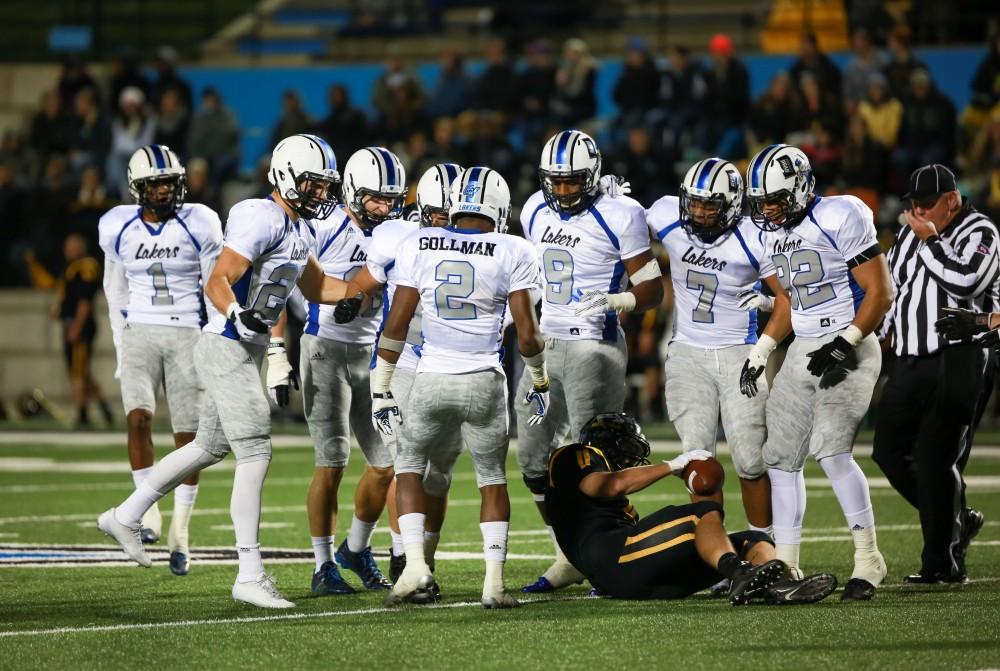 GVL / Kevin Sielaff -  Marquez Gollman (2) and company huddle around a tackled Michigan Tech player.  Grand Valley squares off against Michigan Tech Oct. 17 at Lubbers Stadium in Allendale. The Lakers defeated the Huskies with a score of 38-21.