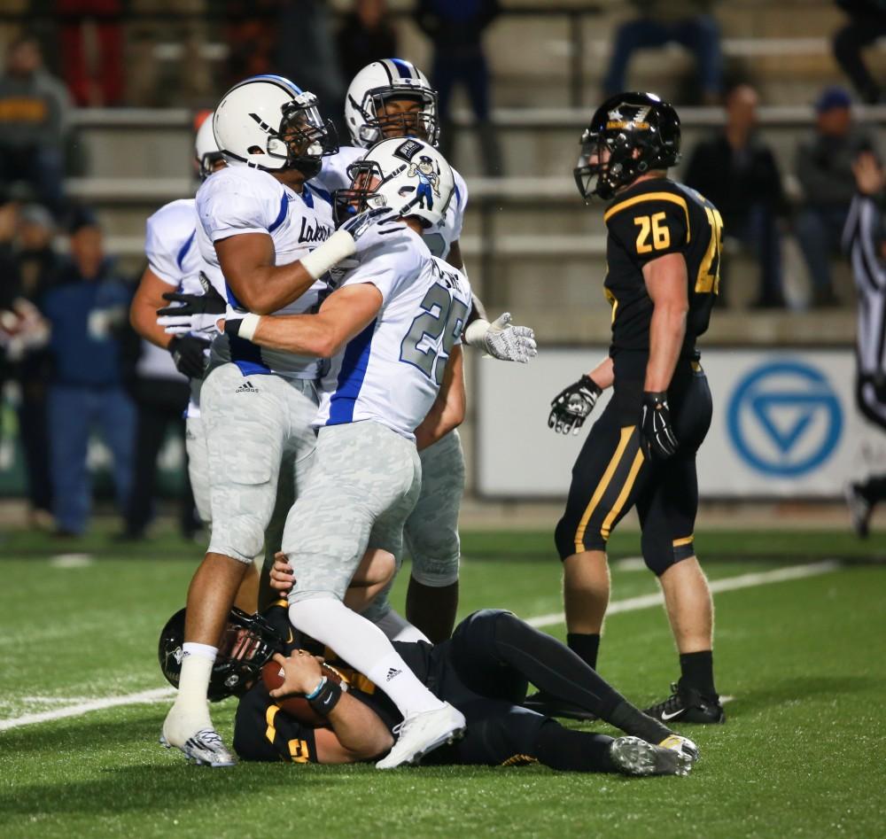 GVL / Kevin Sielaff -  Garrett Pougnet (25) celebrate over the fallen Brandon Cowie (12). Grand Valley squares off against Michigan Tech Oct. 17 at Lubbers Stadium in Allendale. The Lakers defeated the Huskies with a score of 38-21.