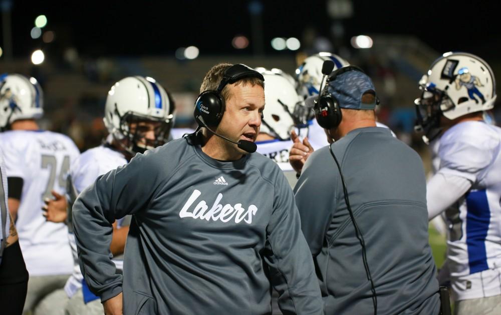 GVL / Kevin Sielaff  - Head coach Matt Mitchell speaks to his players on the sideline.  Grand Valley squares off against Michigan Tech Oct. 17 at Lubbers Stadium in Allendale. The Lakers defeated the Huskies with a score of 38-21.