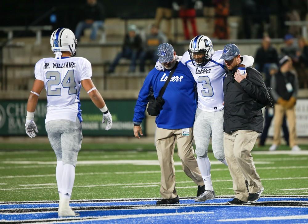 GVL / Kevin Sielaff -  Brandon Bean (3), injured during a play, has to be helped off the field. Grand Valley squares off against Michigan Tech Oct. 17 at Lubbers Stadium in Allendale. The Lakers defeated the Huskies with a score of 38-21.