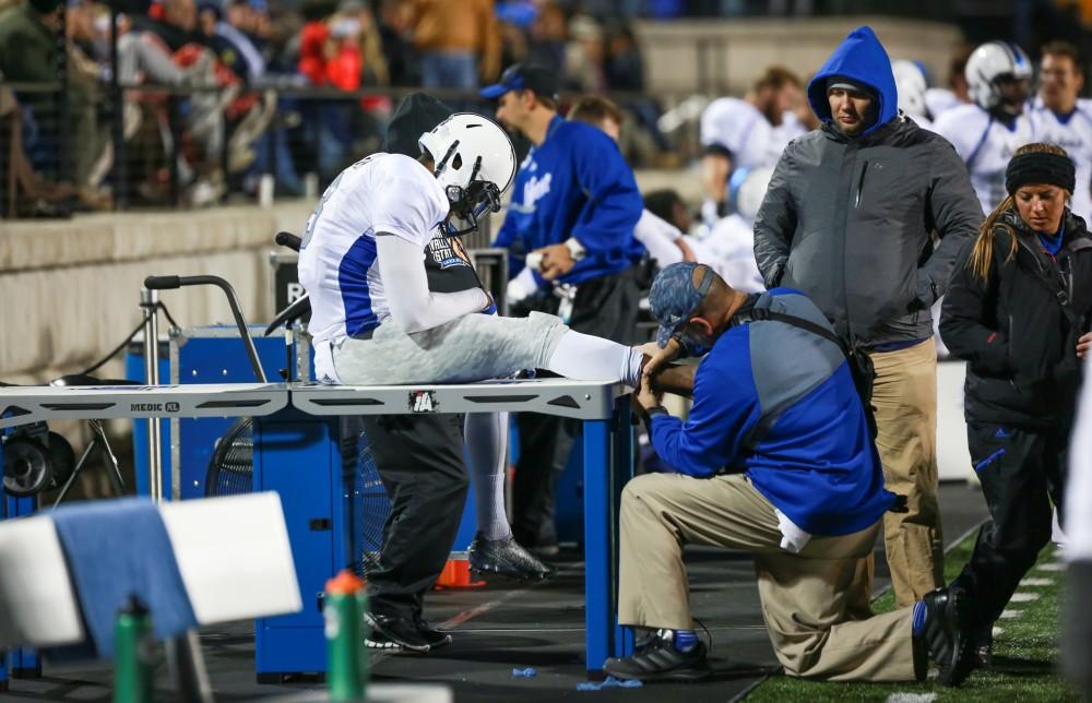 GVL / Kevin Sielaff -  Brandon Bean (3) is tended to on the Grand Valley sideline.  Grand Valley squares off against Michigan Tech Oct. 17 at Lubbers Stadium in Allendale. The Lakers defeated the Huskies with a score of 38-21.