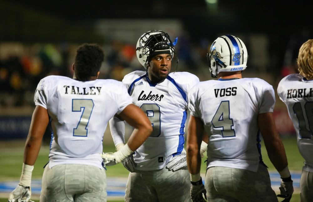 GVL / Kevin Sielaff -  Matt Judon (9) huddles with his teammates on the sideline. Grand Valley squares off against Michigan Tech Oct. 17 at Lubbers Stadium in Allendale. The Lakers defeated the Huskies with a score of 38-21.