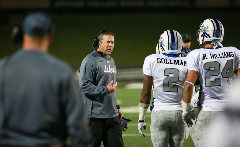 GVL / Kevin Sielaff -  Head coach Matt Mitchell consults his men on the sideline.  Grand Valley squares off against Michigan Tech Oct. 17 at Lubbers Stadium in Allendale. The Lakers defeated the Huskies with a score of 38-21.