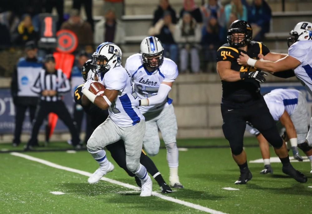 GVL / Kevin Sielaff -  Kirk Spencer (27) breaks a tackle and sprints down field.  Grand Valley squares off against Michigan Tech Oct. 17 at Lubbers Stadium in Allendale. The Lakers defeated the Huskies with a score of 38-21.