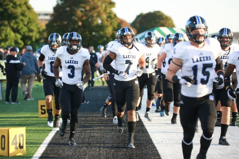 GVL / Kevin Sielaff - Brandon Bean (3) and David Talley (7) trot onto the field before the match. Grand Valley squares off against Wayne State University Oct. 11 in Detroit, MI. The Lakers surged to a 38-17 victory vs. the Warriors.