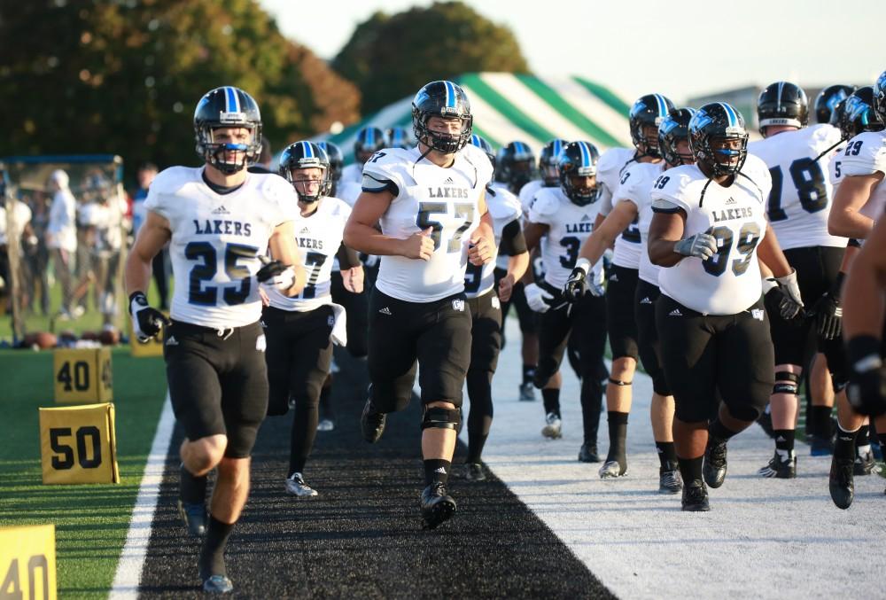 GVL / Kevin Sielaff - Brandon Revenberg (57) trots onto the field before the match. Grand Valley squares off against Wayne State University Oct. 11 in Detroit, MI. The Lakers surged to a 38-17 victory vs. the Warriors.