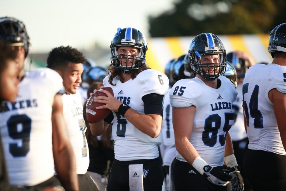 GVL / Kevin Sielaff - Bart Williams (6) warms up his arm on the sideline. Grand Valley squares off against Wayne State University Oct. 11 in Detroit, MI. The Lakers surged to a 38-17 victory vs. the Warriors.