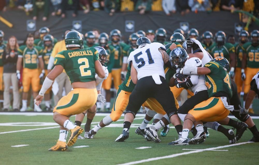 GVL / Kevin Sielaff - Kirk Spencer (27) rams through the Warrior defense. Grand Valley squares off against Wayne State University Oct. 11 in Detroit, MI. The Lakers surged to a 38-17 victory vs. the Warriors.