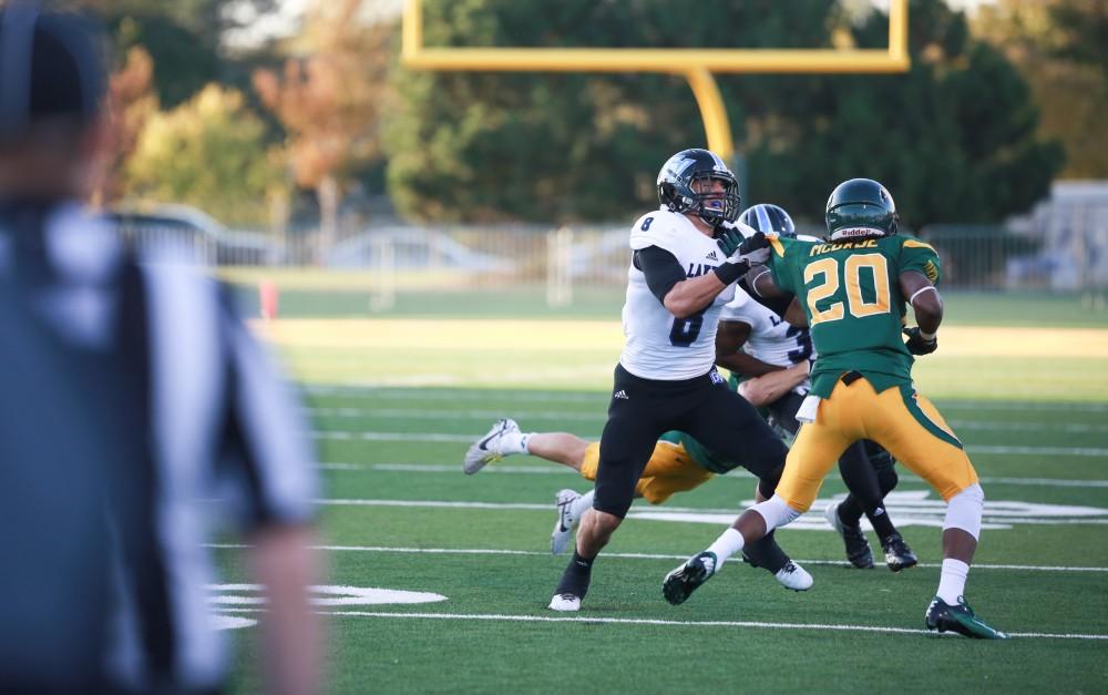 GVL / Kevin Sielaff - Joe Robbins (8) muscles a Warrior away from Brandon Bean (3). Grand Valley squares off against Wayne State University Oct. 11 in Detroit, MI. The Lakers surged to a 38-17 victory vs. the Warriors.