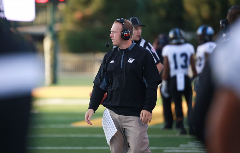 GVL / Kevin Sielaff - Co-defensive coordinator Nick Postma patrols the sideline. Grand Valley squares off against Wayne State University Oct. 11 in Detroit, MI. The Lakers surged to a 38-17 victory vs. the Warriors.