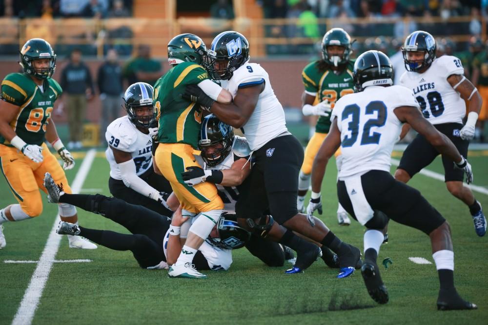 GVL / Kevin Sielaff - Matt Judon (9) brings a Warrior to the ground. Grand Valley squares off against Wayne State University Oct. 11 in Detroit, MI. The Lakers surged to a 38-17 victory vs. the Warriors.