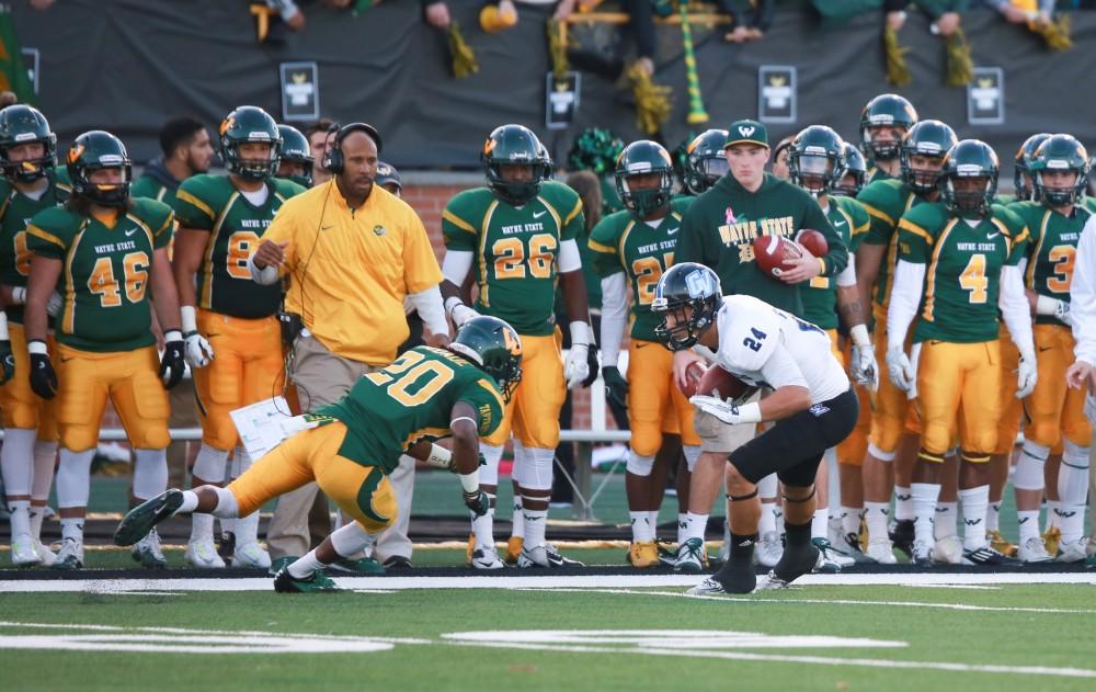 GVL / Kevin Sielaff - Matt Williams (24) gets low and prepares to break a tackle. Grand Valley squares off against Wayne State University Oct. 11 in Detroit, MI. The Lakers surged to a 38-17 victory vs. the Warriors.