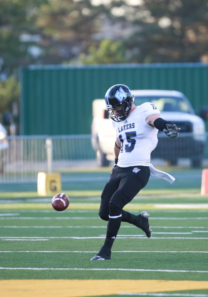 GVL / Kevin Sielaff - Jamie Potts (15) punts the ball away on fourth down. Grand Valley squares off against Wayne State University Oct. 11 in Detroit, MI. The Lakers surged to a 38-17 victory vs. the Warriors.