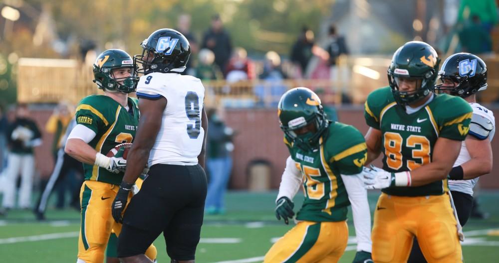 GVL / Kevin Sielaff - Matt Judon (9) exchanges words with Wayne State QB D.J. Zezula. Grand Valley squares off against Wayne State University Oct. 11 in Detroit, MI. The Lakers surged to a 38-17 victory vs. the Warriors.