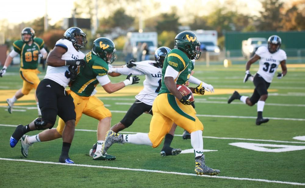 GVL / Kevin Sielaff - Demetrius Stinson (2) of Wayne State heads toward Grand Valley's endzone. Grand Valley squares off against Wayne State University Oct. 11 in Detroit, MI. The Lakers surged to a 38-17 victory vs. the Warriors.