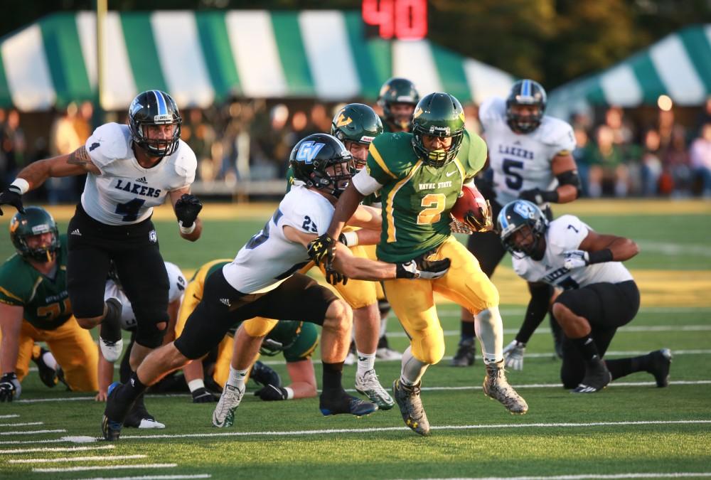 GVL / Kevin Sielaff - Wayne State's Demetrius Stinson (2) attemps to break through the Grand Valley defensive line. Grand Valley squares off against Wayne State University Oct. 11 in Detroit, MI. The Lakers surged to a 38-17 victory vs. the Warriors.