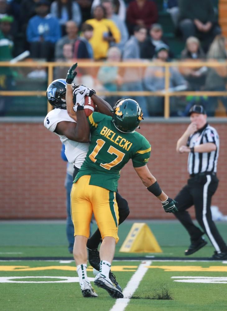 GVL / Kevin Sielaff - Brandon Bean (3) rises up to fight for a catch against Wayne State's Zak Bielecki (17). Grand Valley squares off against Wayne State University Oct. 11 in Detroit, MI. The Lakers surged to a 38-17 victory vs. the Warriors.