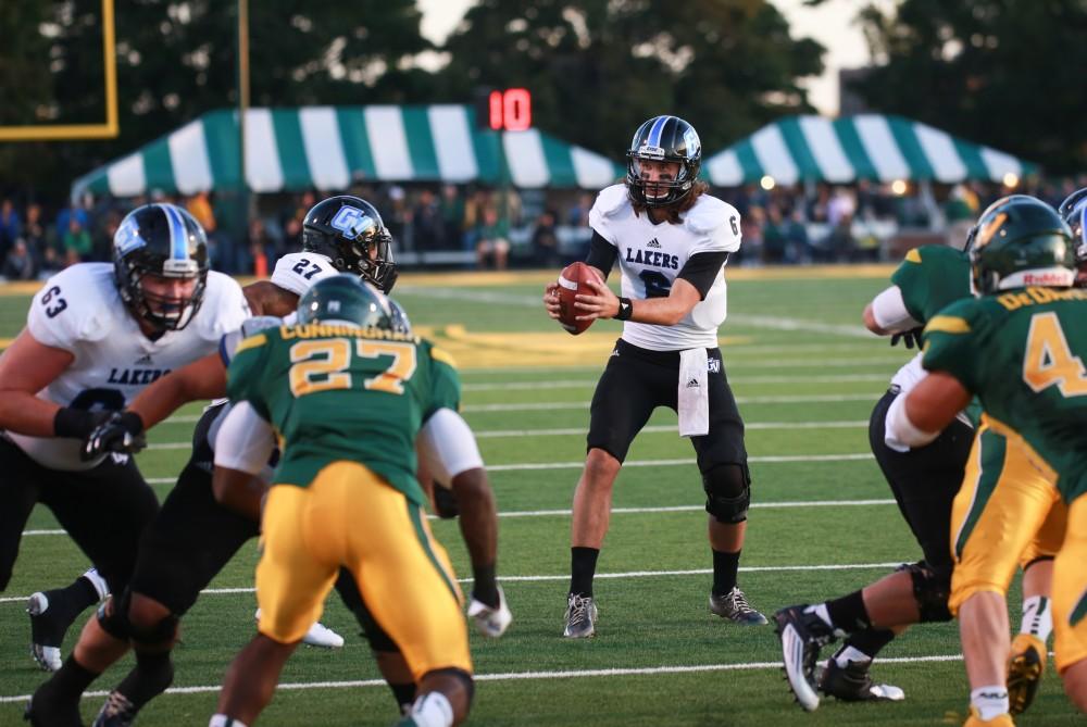 GVL / Kevin Sielaff - Bart Williams (6) looks to hand the ball off to Kirk Spencer (27). Grand Valley squares off against Wayne State University Oct. 11 in Detroit, MI. The Lakers surged to a 38-17 victory vs. the Warriors.