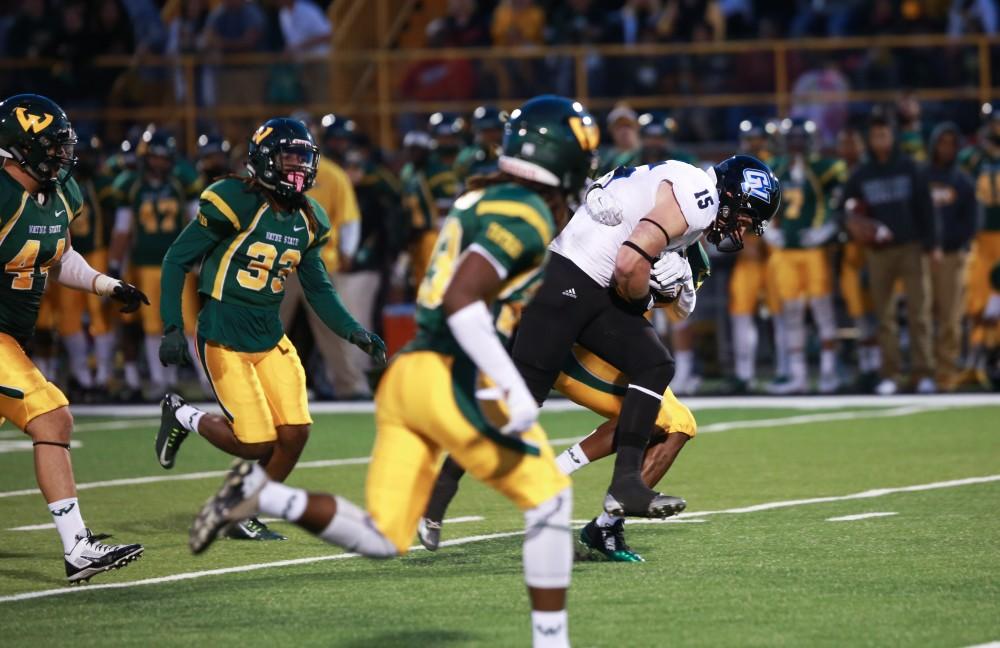 GVL / Kevin Sielaff - Jamie Potts (6) breaks a tackle as he heads toward the endzone. Grand Valley squares off against Wayne State University Oct. 11 in Detroit, MI. The Lakers surged to a 38-17 victory vs. the Warriors.