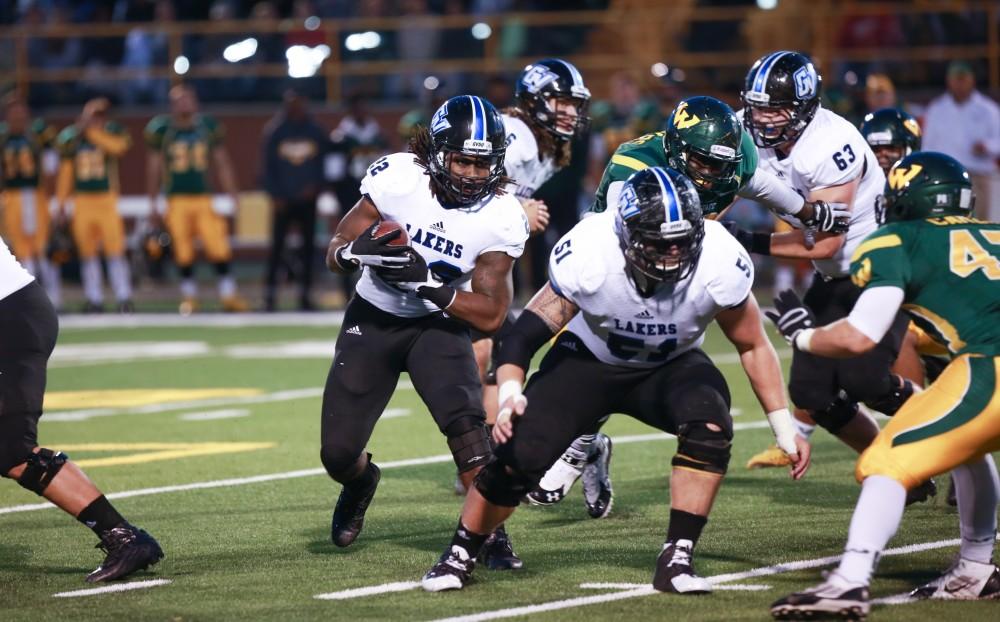 GVL / Kevin Sielaff - Terrell Dorsey (22) gets a block and penetrates the Warrior defense. Grand Valley squares off against Wayne State University Oct. 11 in Detroit, MI. The Lakers surged to a 38-17 victory vs. the Warriors.