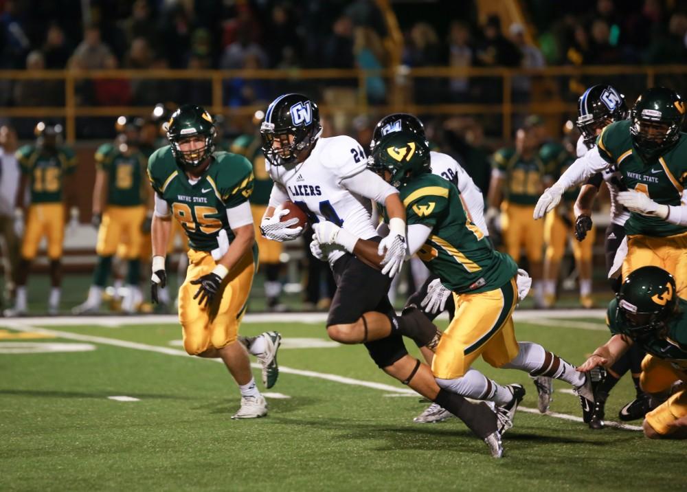 GVL / Kevin Sielaff - Matt Williams (24), after breaking through the Warrior defense, is tackled from behind. Grand Valley squares off against Wayne State University Oct. 11 in Detroit, MI. The Lakers surged to a 38-17 victory vs. the Warriors.