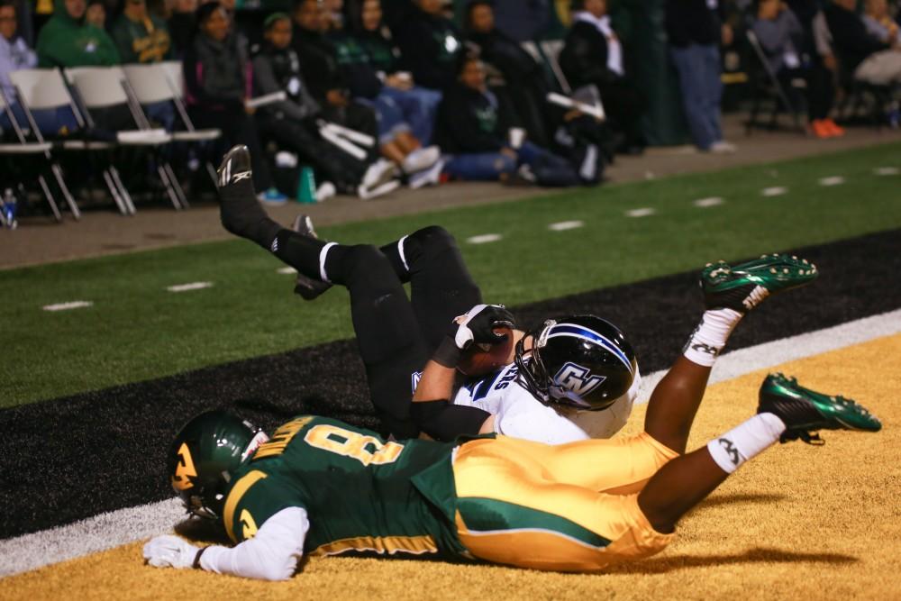 GVL / Kevin Sielaff - Jamie Potts (15) fights to receive a pass in the end zone and falls to the ground. Grand Valley squares off against Wayne State University Oct. 11 in Detroit, MI. The Lakers surged to a 38-17 victory vs. the Warriors.