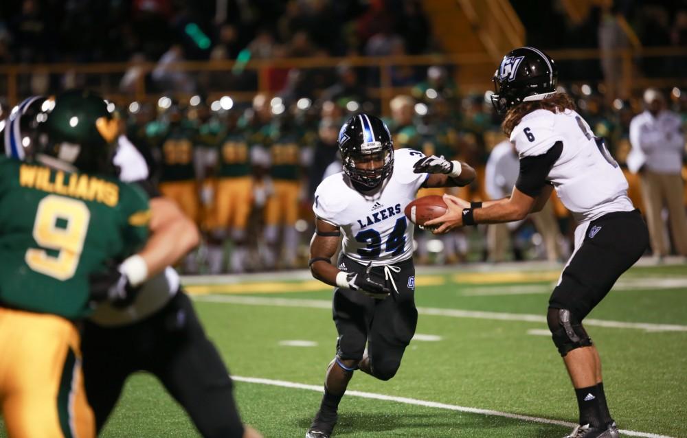 GVL / Kevin Sielaff - Bart Williams (6) hands the ball off to Marty Carter (34). Grand Valley squares off against Wayne State University Oct. 11 in Detroit, MI. The Lakers surged to a 38-17 victory vs. the Warriors.