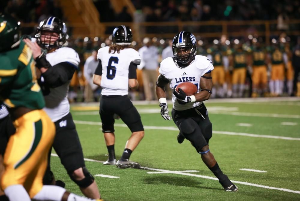 GVL / Kevin Sielaff - Marty Carter (34) scanes the Warrior defense for an opening. Grand Valley squares off against Wayne State University Oct. 11 in Detroit, MI. The Lakers surged to a 38-17 victory vs. the Warriors.