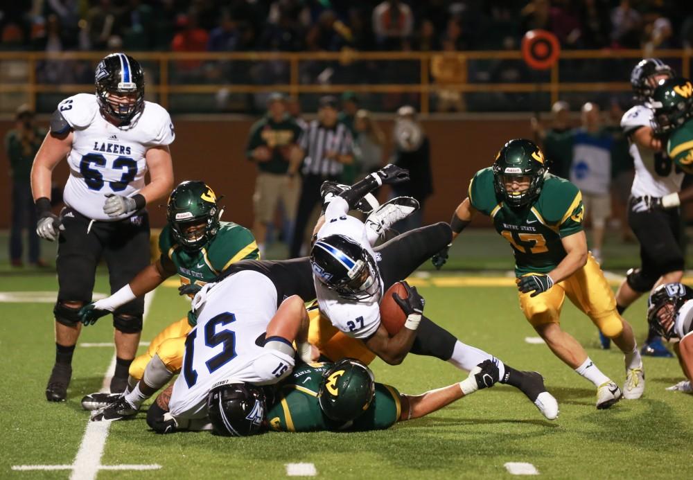 GVL / Kevin Sielaff - Kirk Spencer (27) pushes through the Warrior defense. Grand Valley squares off against Wayne State University Oct. 11 in Detroit, MI. The Lakers surged to a 38-17 victory vs. the Warriors.