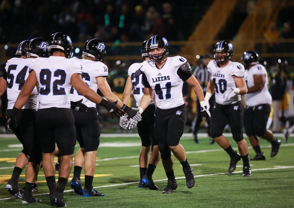 GVL / Kevin Sielaff - Nick Keizer (41) high-fives his teammates. Grand Valley squares off against Wayne State University Oct. 11 in Detroit, MI. The Lakers surged to a 38-17 victory vs. the Warriors.