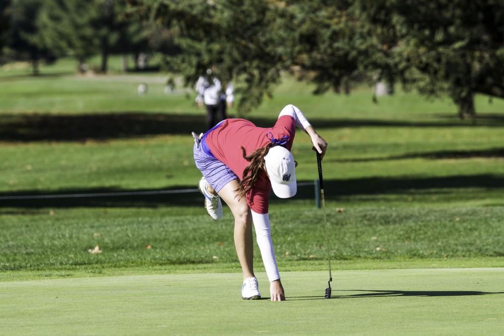 GVL / Sara Carte
Grand Valley Girl’s Golf player, Danielle Crilley, grabs her ball from the ninth hole during the Davenport Invitational at the Blythefield Country Club on Oct. 26.