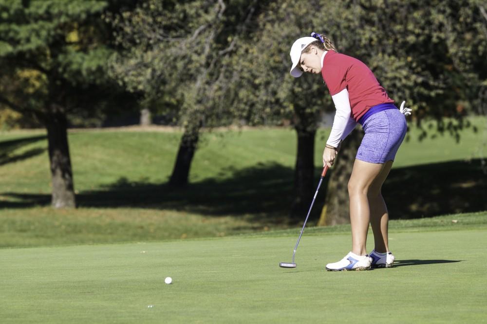 GVL / Sara Carte
Grand Valley Girl’s Golf player, Alex Taylor, puts the ball on the ninth hole during the Davenport Invitational at the Blythefield Country Club on Oct. 26.