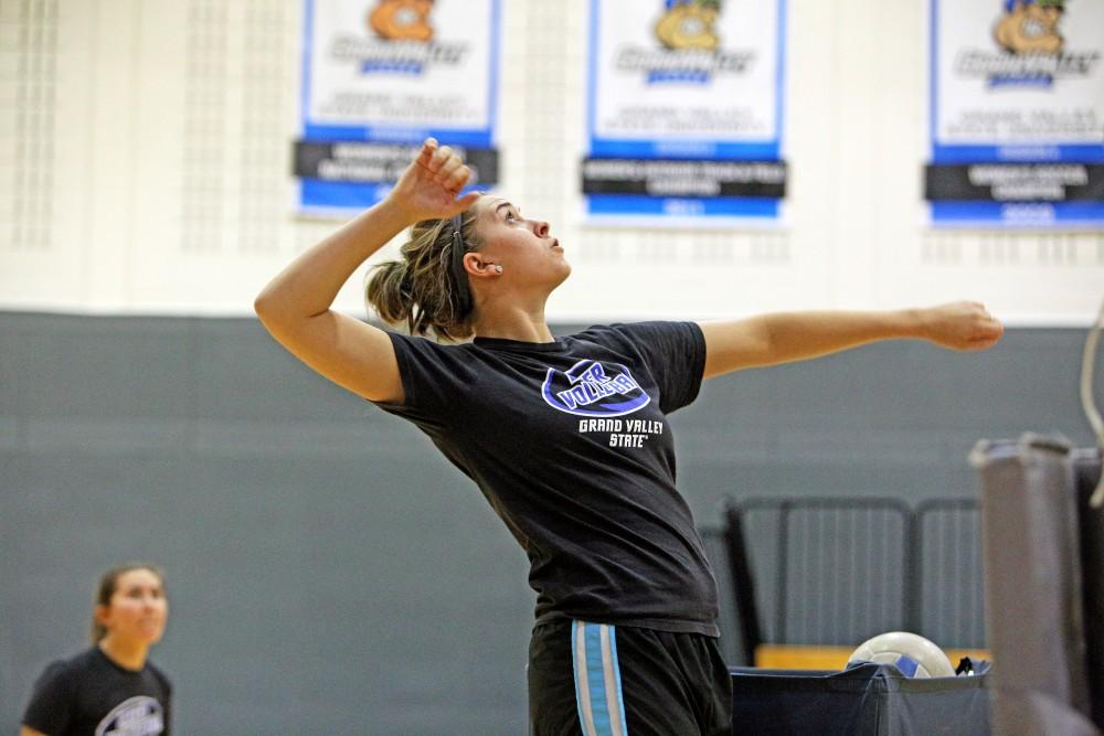 GVL / Emily Frye      
Senior Carly Gross assists the volleyball team with drills during practice on Oct. 20th. Gross suffered a back injury during the off season in spring 2015. However, after undergoing back surgery, it is unknown when or if she will be able to return to the court. 