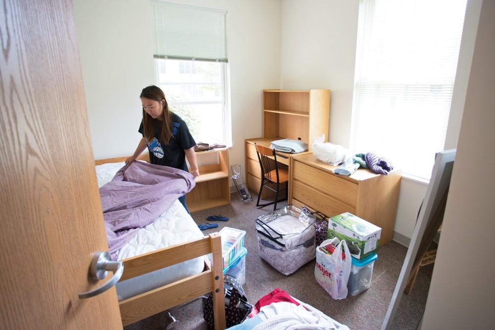 GVL / Kevin Sielaff  Emily Wang, a junior attending Grand Valley State, moves into her dorm early to avoid the crowds of move-in week on Saturday, August 22nd, 2015. Move-in week draws thousands each year to Grand Valleys Allendale and Pew campuses as under and upper classmen alike prepare for the school year.