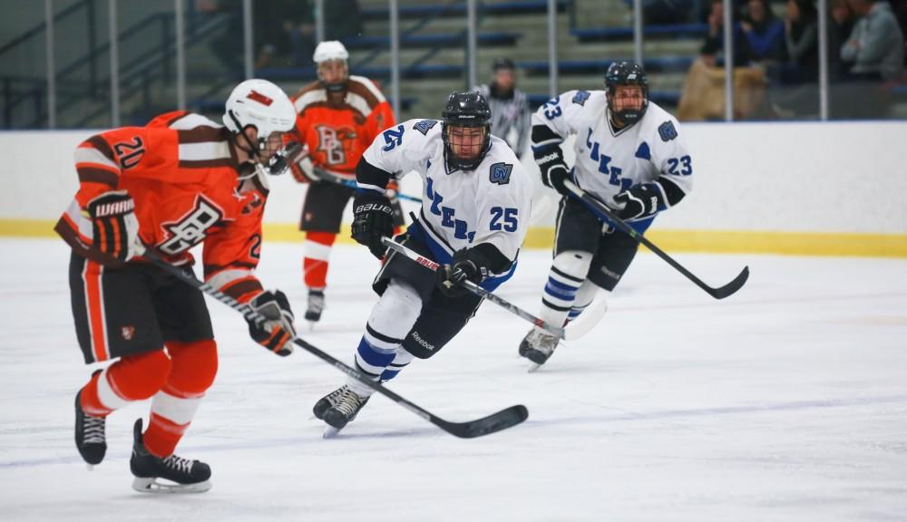 GVL / Kevin Sielaff -  Nick Schultz (25) races toward the puck. Grand Valleys Divison II mens hockey squad squares off against Bowling Green University Oct. 16 at Georgetown Ice Arena.