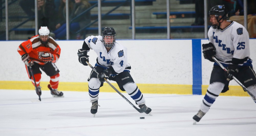 GVL / Kevin Sielaff - Tom Lusynski (4) lines up a shot. Grand Valley's Divison II men's hockey squad squares off against Bowling Green University Oct. 16 at Georgetown Ice Arena.