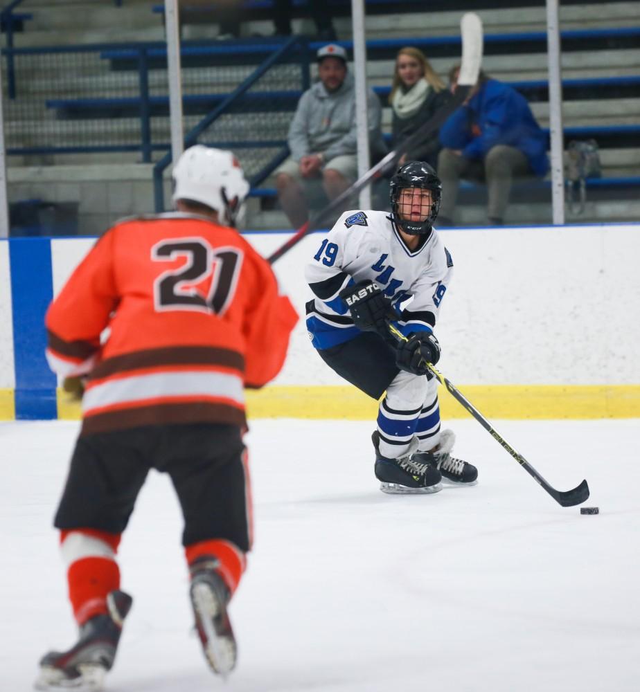 GVL / Kevin Sielaff - Collin Finkhouse (19) looks for a cross-crease pass.  Grand Valley's Divison II men's hockey squad squares off against Bowling Green University Oct. 16 at Georgetown Ice Arena.