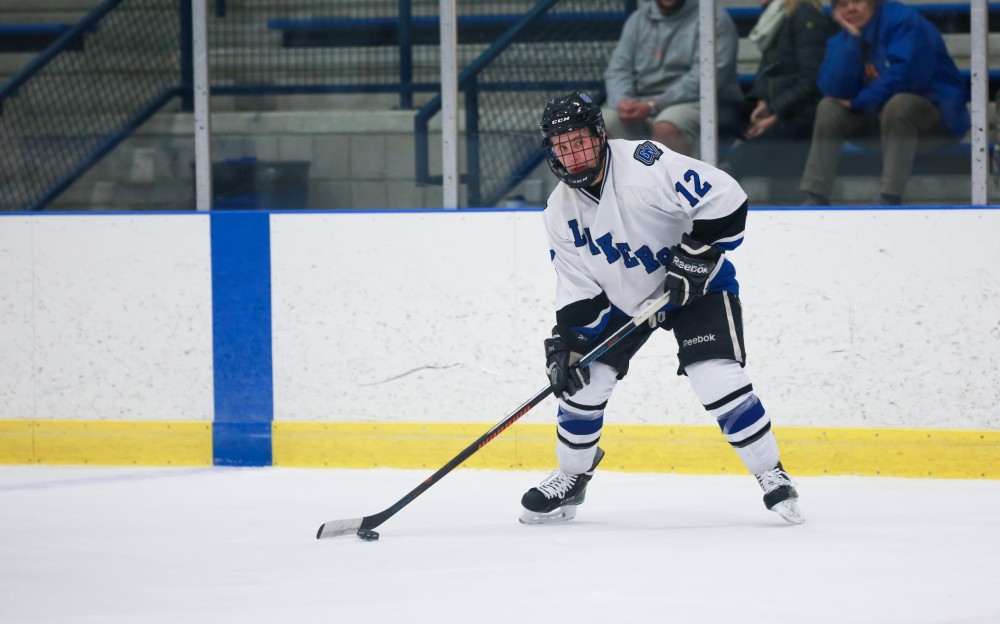 GVL / Kevin Sielaff - Reede Burnett (12) lines up a pass. Grand Valley's Divison II men's hockey squad squares off against Bowling Green University Oct. 16 at Georgetown Ice Arena.