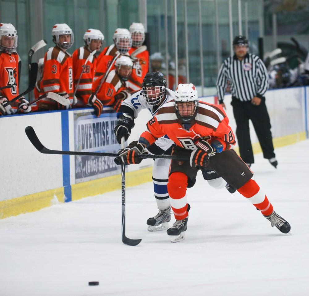 GVL / Kevin Sielaff - Zac Strain (22) battles for position with Bowling Green's Aaron Natyshak (18).  Grand Valley's Divison II men's hockey squad squares off against Bowling Green University Oct. 16 at Georgetown Ice Arena.